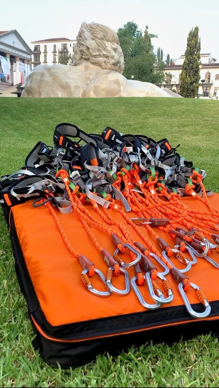 Petzl harnesses, pulleys and carabiners ready on the grass